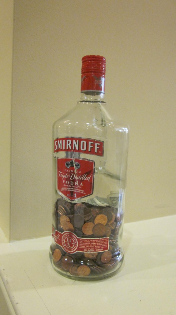 A vodka bottle filled with change