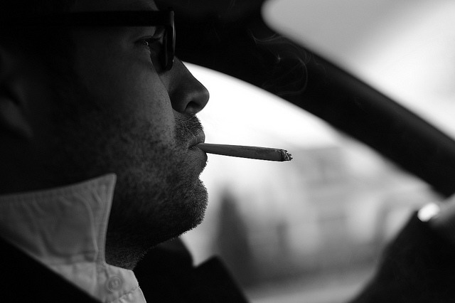 Smoking in a car. by Wout de Jong