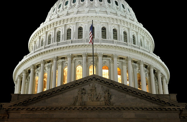 U.S. capitol at night with flag