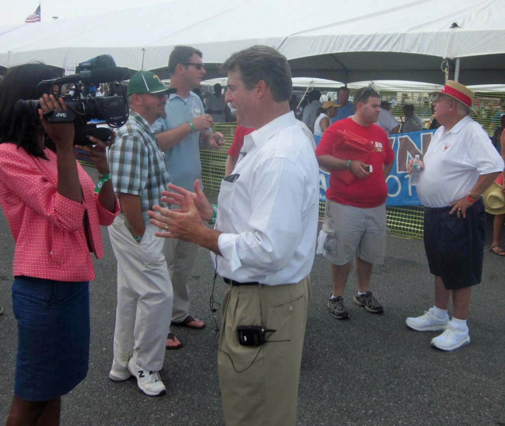 Attorney General Doug Gansler, center, an unannounced candidate for governor, talks to a TV reporter as Gansler aide Alan Brody (red shirt) talks to Del. Johnny Wood, in hat, D-St. Mary's.