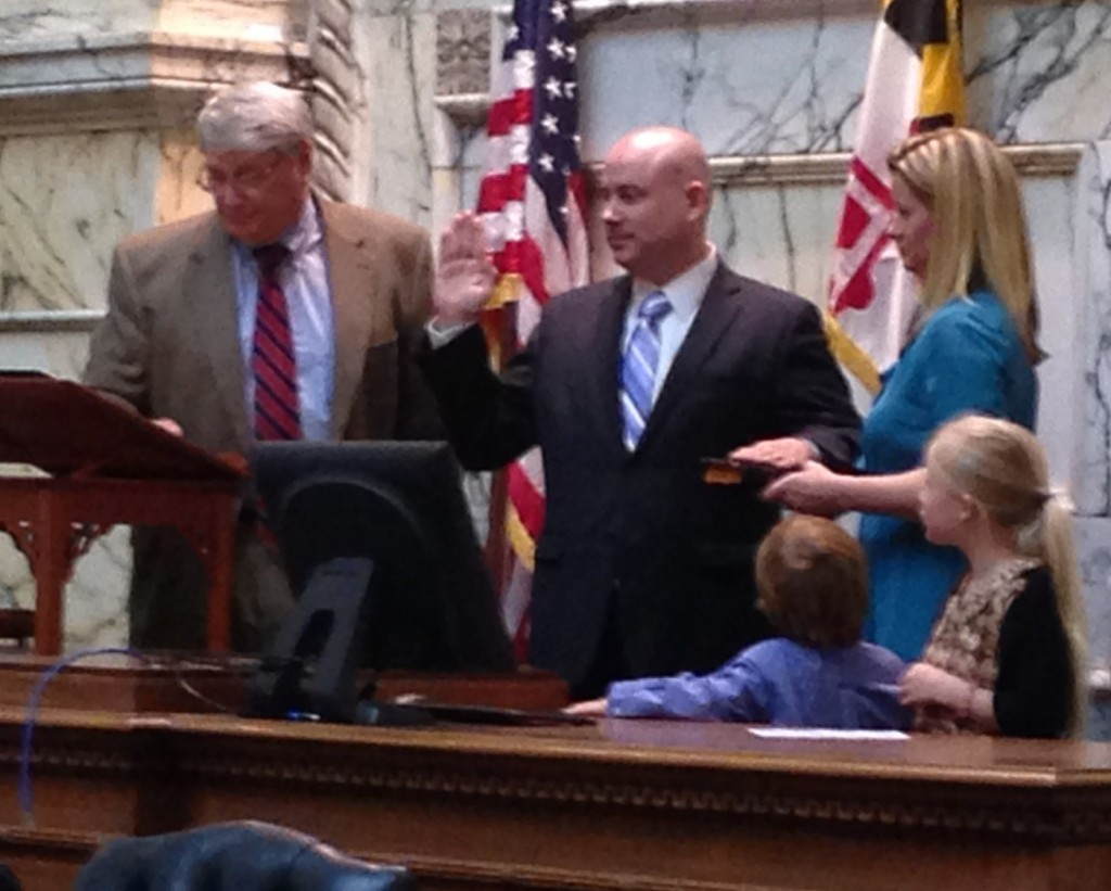House of Delegates Speaker Michael Busch, far left, swears in David Fraser-Hidalgo as a new member as Fraser-Hidalgo's wife and kids look on. Gov. Martin O'Malley appointed the new Montgomery County delegate to replace Brian Feldman who was named and sworn in as a state senator for District 15 last month. .