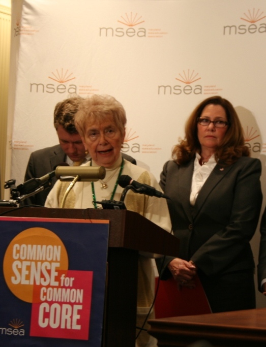 Ways & Means Chair Sheila Hixson at podium, with Del. Eric Luedtke and MSEA President Betty Weller