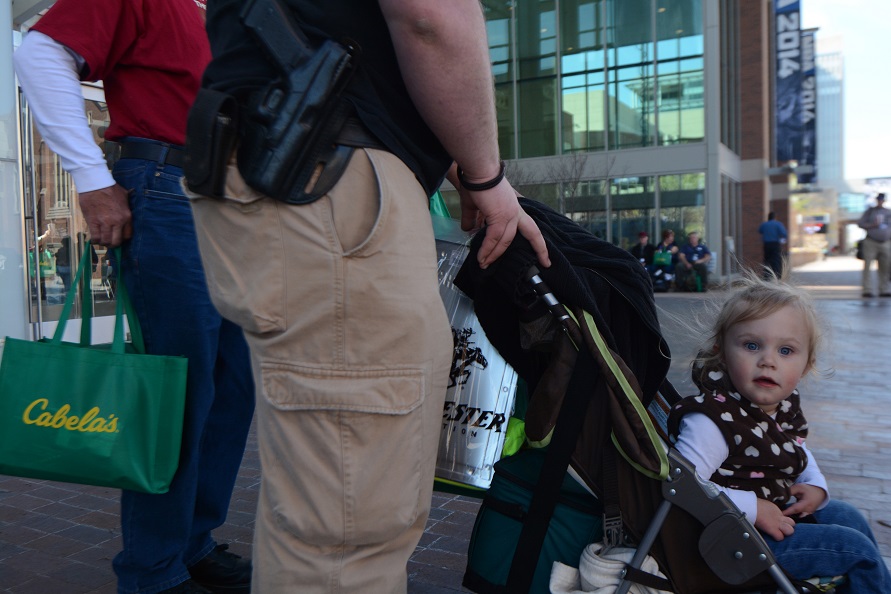 Two-year-old Aleks Gifford looks on as her mother, Kaitlynn Gifford, leaves the National Rifle Association's 143rd annual convention in Indianapolis on April 25, 2014. Photo by Jacob Byk/News21.