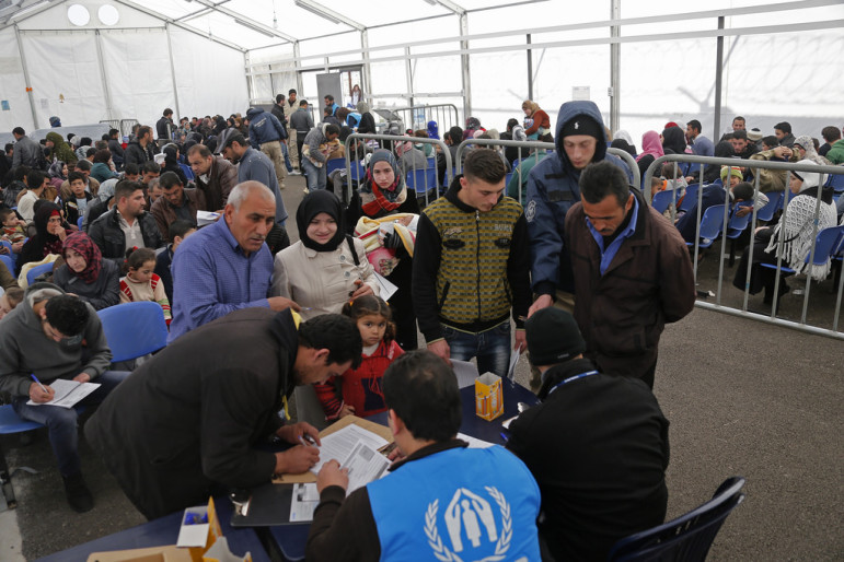 A family submitting an application at the U.N. High Commission for Refugees registration center in Tripoli-Lebanon in 2014. By Mohamed Azakir, World Bank Photo-Collection with Flickr Creative Commons License. 
