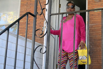 Sharlene Adams, on the porch of the rowhome she rents in West Baltimore, relies on the city's unpredictable public transportation network to get to health appointments.