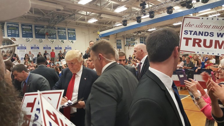 Donald Trump autographs signs at Stephen Decatur High in Berlin Wednesday night. 