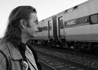 Gregory Sanders, long time public transit advocate and the vice president of the Purple Line Now coalition. Here, he stands in front of a MARC train at the College Park Metro station, which he takes every day from his home in Ellicott City. His father, Harry Sanders, first proposed the Purple Line. 