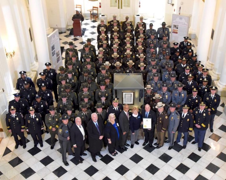 Gov. Larry Hogan stands with police in the rotunda of the State House, holding the proclamation declaring Monday as Law Enforcement Appreciation Day. Governor's Office photo. 
