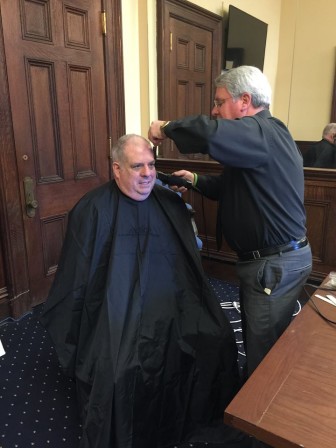 Gov. Larry Hogan gets his first haircut as his hair starts to come back after chemotherapy. 