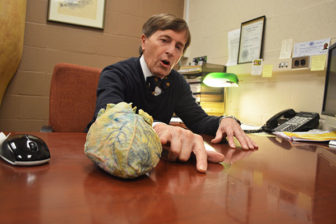State Anatomy Board Director Ronn Wade explains what hypertension looks like on one of three silicon-laced hearts he keeps in his office at the University of Maryland School of Medicine, April 5, 2016. 