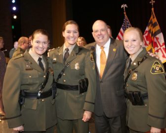 The Natural Resources Police academy graduated its largest ever class this week. Gov. Larry Hogan is shown here with three of its 27 graduates. Natural Resources photo. 